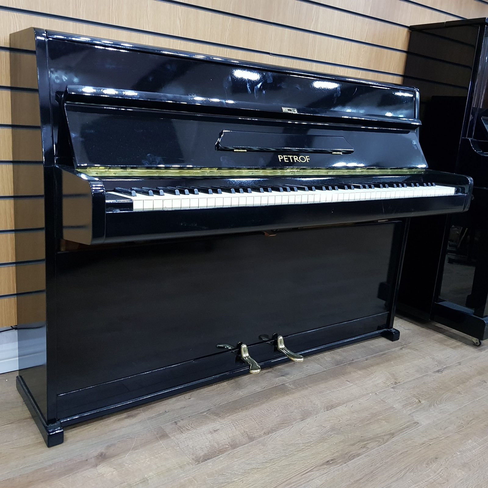 Petrof upright piano, in a black lacquered case for sale.