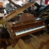 Used Dagmar baby grand piano finished in a mahogany case for sale.