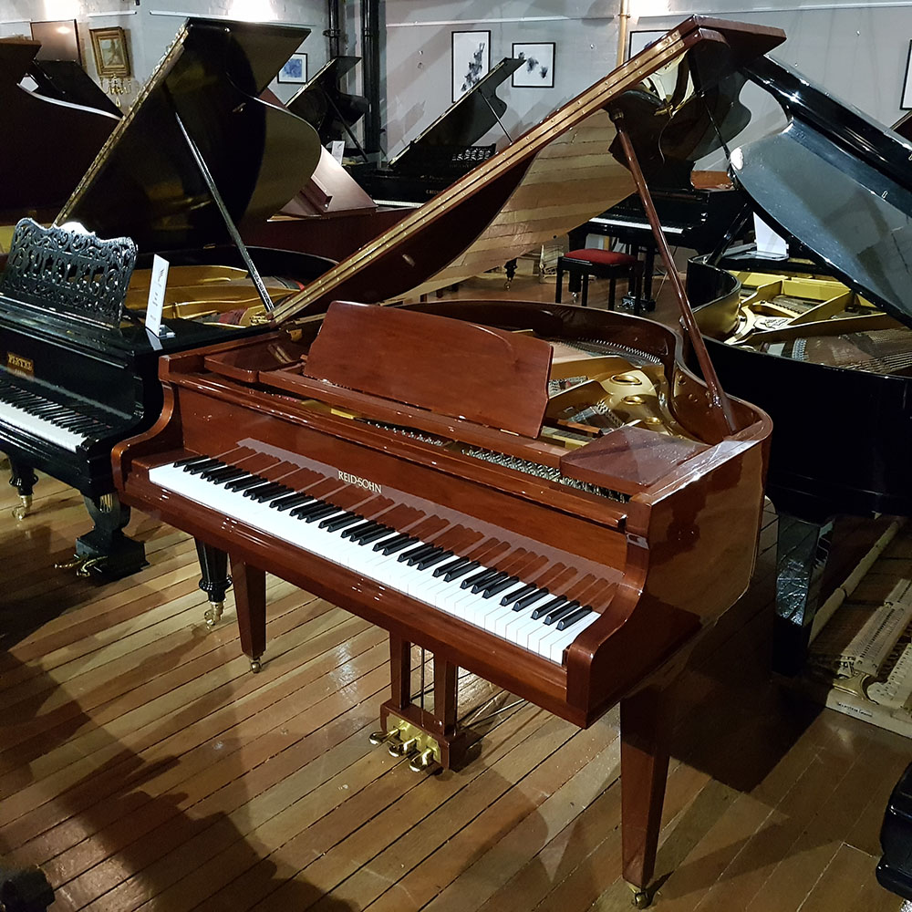 Reid Sohn SG-140A baby grand piano, in a walnut polyester case, for sale.