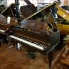 Used challen baby grand piano finished in a mahogany case, for sale.