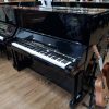 Used Yamaha UX upright piano, in a black polyester case, for sale.