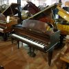 Used Challen baby grand piano for sale in a mahogany case.